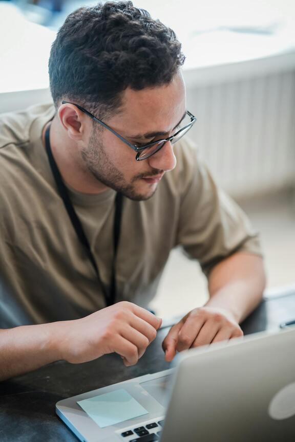 A man in front of his computer in contemplation